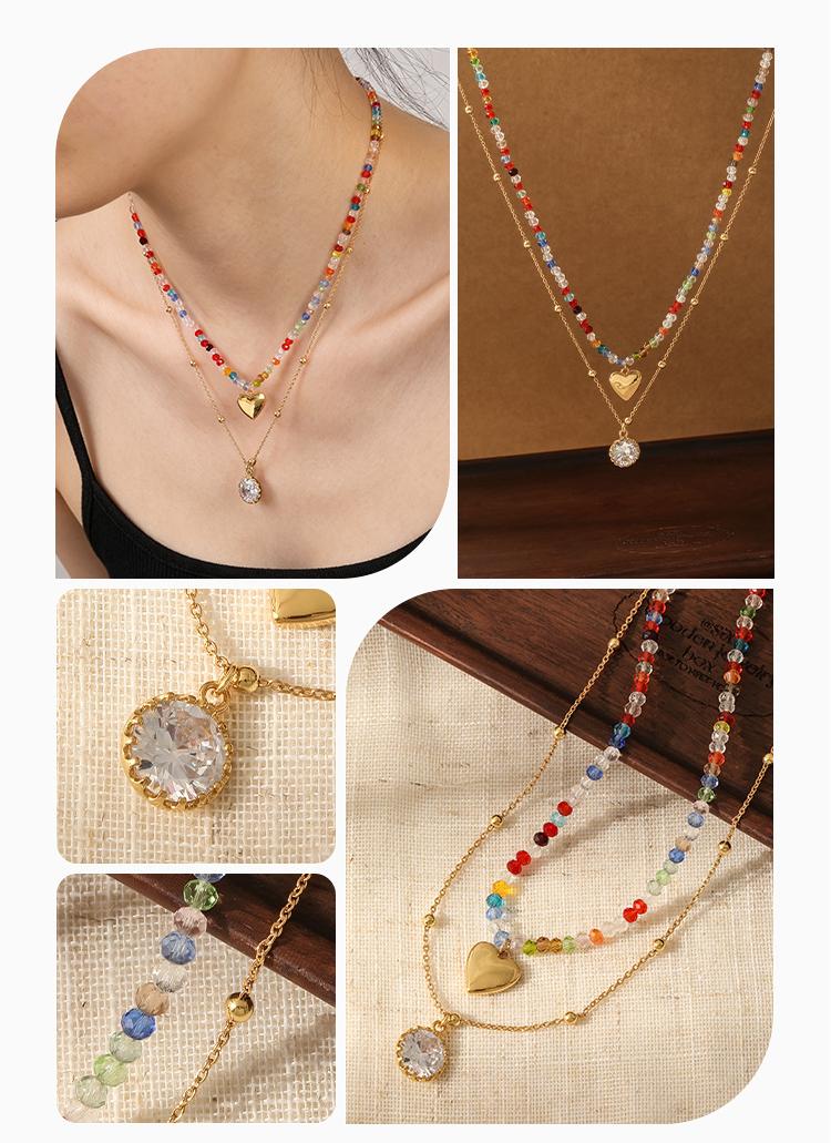 Woman wearing double layer rainbow crystal beaded necklace with gold heart charm and oval crystal pendant on black top